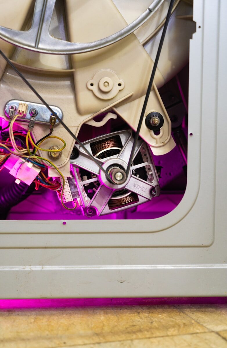 Close-up of washing machine motor and belt mechanism